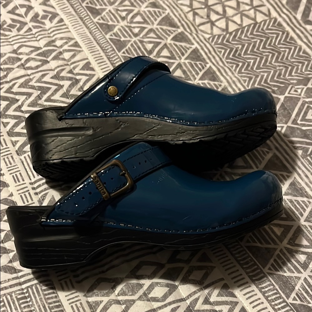 Sanita Freya patent blue open back blue clogs.